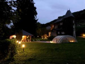 a tent on the grass in a yard at night at LE CLOS DU TULIPIER in La Chapelle-du-Bard