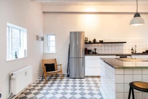 a kitchen with a refrigerator and a checkered floor at The Townhouse by Daniel&Jacob's in Copenhagen