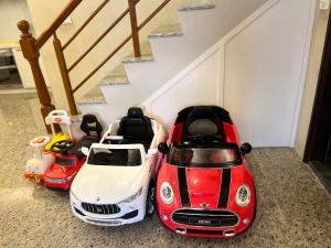two toy cars sitting on the floor next to a staircase at An Egg Homestay in Beipu