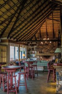 a room with tables and chairs in a building at Parador Cambará do Sul in Cambara do Sul