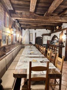 a long dining room with a long table and chairs at Albergo Ristorante Al Fratè da Streza in Madonna di Campiglio