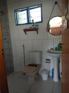 a small bathroom with a toilet and a sink at Casa - Sítio da Tabi - Lagoinha-SP in Lagoinha