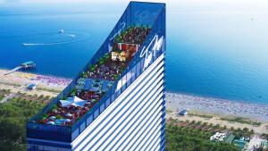 a building on a beach next to the ocean at Orbi City Luxury Panorama in Batumi