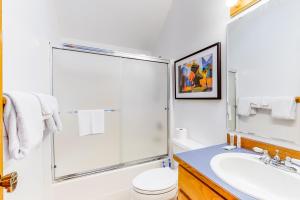 a bathroom with a shower and a toilet and a sink at Shine Road Retreat in Port Ludlow +33 photos