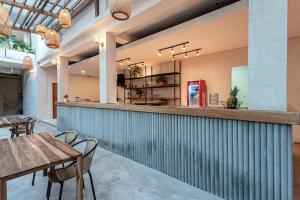 a bar in a restaurant with tables and chairs at Soy Local Santa Marta in Santa Marta