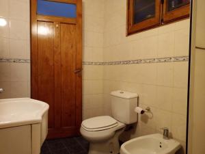 a bathroom with a toilet and a sink at Casa Guevara in San Rafael +14 photos
