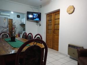 a dining room with a table and a tv on the wall at Casa Guevara in San Rafael
