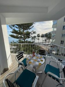 a patio with a table and chairs on a balcony at Edificio Albires in Albir