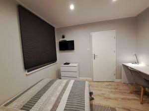 a bedroom with a bed and a sink and a window at Hotel 1 in Płock