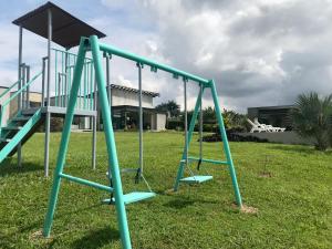 a playground with a slide in a yard at Torcaza Casa de Campo in Quimbaya