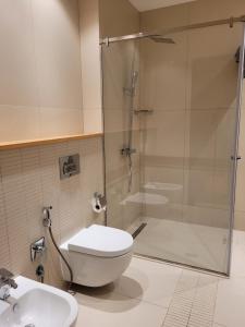 a bathroom with a shower and a toilet and a sink at Sea Breeze Resort, White Villa, Nardaran in Baku