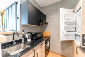 a kitchen with a sink and a counter top at Stayhere Casablanca - Gauthier 1 - Modern Residence in Casablanca