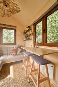 a tiny house with a kitchen and a couch at Tiny House Örebro in Örebro