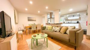 a living room with a couch and a table at BENAMAR HOUSE in Quarteira