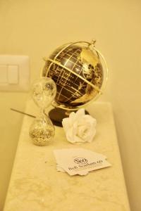 a table with a clock and a flower on it at B&B Scarlatti 60 in Naples