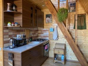 a kitchen with a sink and a stove in a cabin at Cozy cabin in Tbilisi City