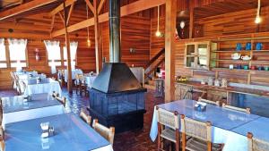 a restaurant with tables and a stove in a room at Pousada Vereda do Sol in Cambará