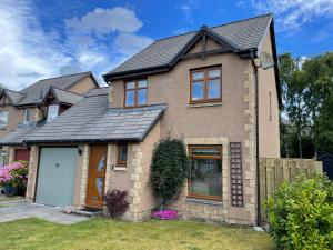 una casa in mattoni con tetto nero di The Bosie ad Aviemore