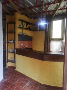 a kitchen with a yellow counter and a window at CASA JUANA DE ORO in Baños