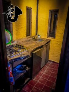 a kitchen with a sink and a stove top oven at CASA JUANA DE ORO in Baños