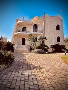 a large brick building with a staircase in front of it at Villa Pignatelli in Bari