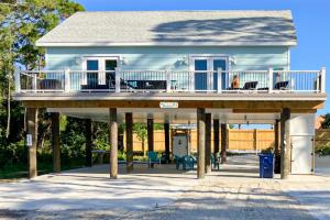 a house with a porch and a deck at The Birdhouse in St. George Island