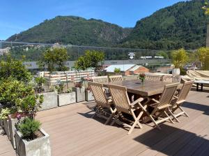 a wooden deck with a table and chairs on a roof at Apartamento Park Way Bogotá in Bogotá