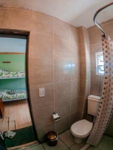 a bathroom with a toilet and a shower at Hostel Like Quijote in San Carlos de Bariloche