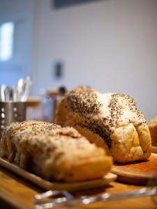 two loaves of bread on a plate on a table at Hostel Like Quijote in San Carlos de Bariloche +47 photos