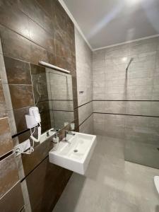 a bathroom with a sink and a mirror at Leo Rooms in Lviv