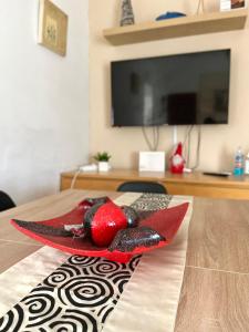 a red bird sitting on top of a table at Apartamento Hifrensa in Hospitalet de l'Infant
