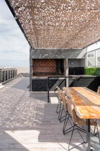 a patio with a wooden table and chairs on a building at Top Rentals Palermo Hollywood in Buenos Aires
