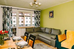 a living room with a couch and a table at Apartament blisko Czarnej Góry in Stronie Śląskie