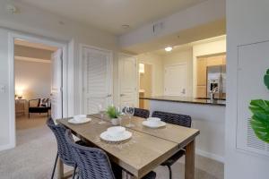 a dining room with a wooden table and chairs at Spectacular 1BR Condo Located At Pentagon City in Arlington