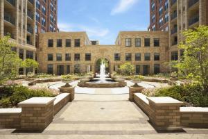 a courtyard with a fountain in front of a building at Spectacular 1BR Condo Located At Pentagon City in Arlington