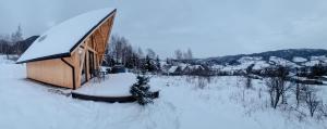 a small building covered in snow in a field at Heart and Soul in Tylmanowa