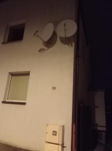 a building with two satellite dishes on the side of it at Apartment parking loft Akaciju in Vilnius