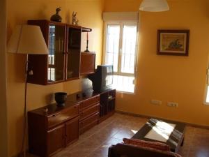 a living room with a tv on a dresser at Apartment - 2 Bedrooms - 00119 in Vigo