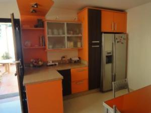 a kitchen with orange cabinets and a refrigerator at Villa - 4 Bedrooms with Pool and WiFi - 01404 in Chilches