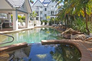 a swimming pool in a yard with a resort at The Bay 23 in Gold Coast