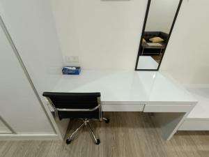 a desk with a chair in front of a mirror at The Perfect Retreat @One Bukit Ceylon (UNIT 25-2) in Kuala Lumpur