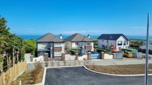 a row of houses with the ocean in the background at Entire Modern Home with seaview and parking in Wicklow