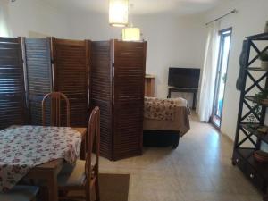 a room with a table and a bed and a table and chairs at Agradable casa con piscina en la serranía. in Arriate