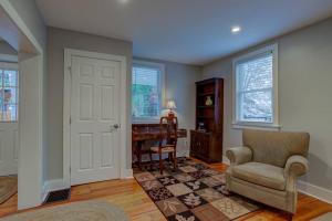 a living room with a chair and a desk at Calla Lily Farmhouse in Manheim