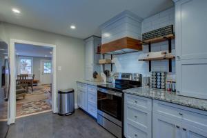 a kitchen with white cabinets and a stove top oven at Calla Lily Farmhouse in Manheim