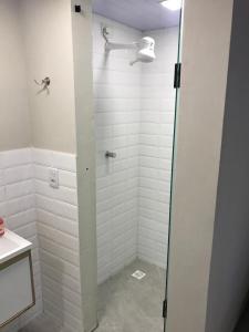 a shower with a glass door in a bathroom at Recanto do Mar in Pipa