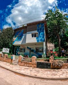 a house with a painting on the side of it at Hostel Like Quijote in San Carlos de Bariloche