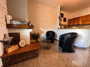 a living room with two chairs and a fireplace at B & B Dal Barone in Sulmona