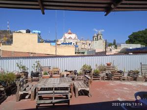 a picnic table and chairs on a patio at Hostal San Pueblo in Oaxaca City