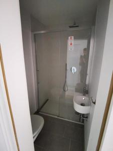 a man taking a picture of a bathroom with a sink at Lovely 3 Bedroom Apt. in Maloja